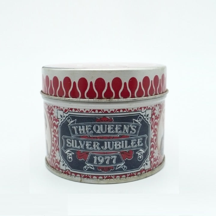 A round metal Matchbox Tin with a lithograph label reading 'THE QUEEN'S SILVER JUBILEE 1977' in red, white, and navy blue, photographed on a plain white background.
