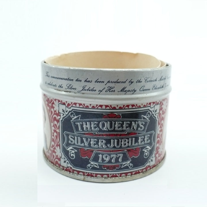 A vintage cylindrical metal Matchbox Tin with a printed label reading 'THE QUEEN'S SILVER JUBILEE 1977' on a white background.