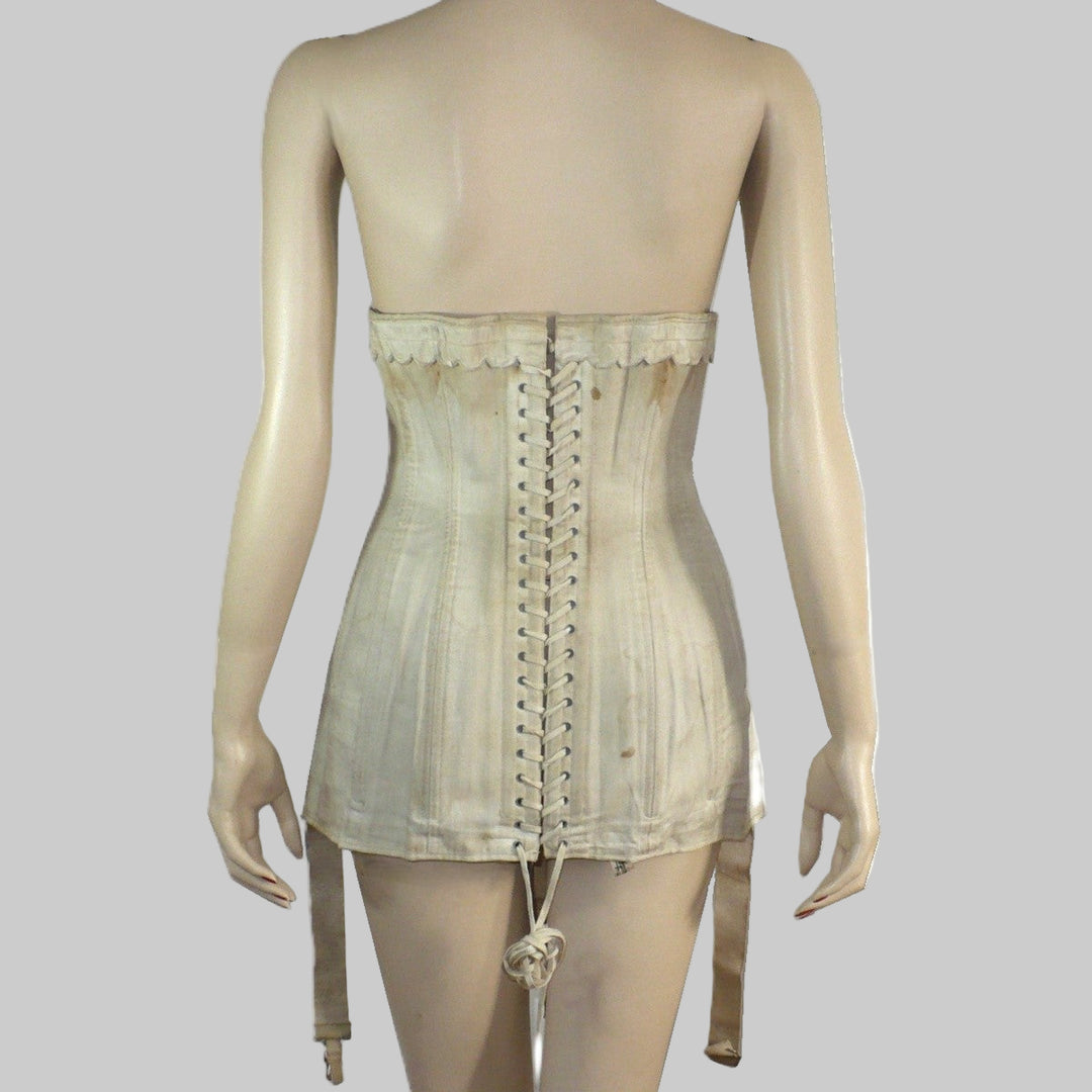 Mannequin wearing an Edwardian corset, back view.