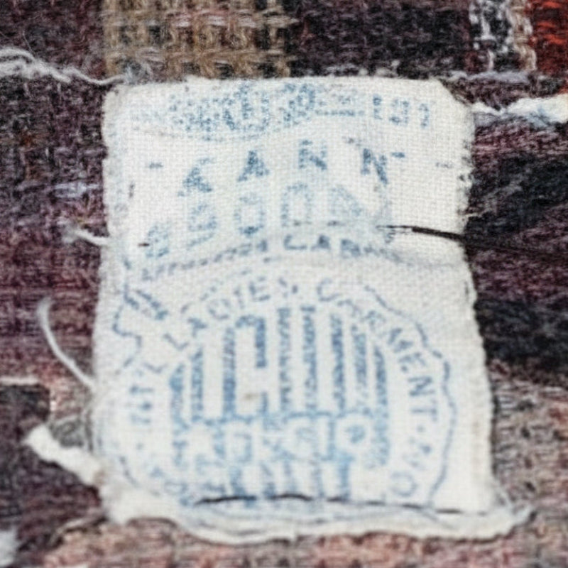 Close-up views of "Designed by Shannon Rodgers" designer label alongside the ILGWU union label.