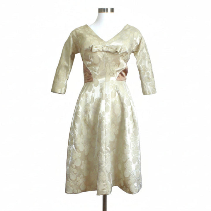 Front angle view of the 1960s Mardi Gras champagne white jacquard dress showcasing its structured A-line silhouette.