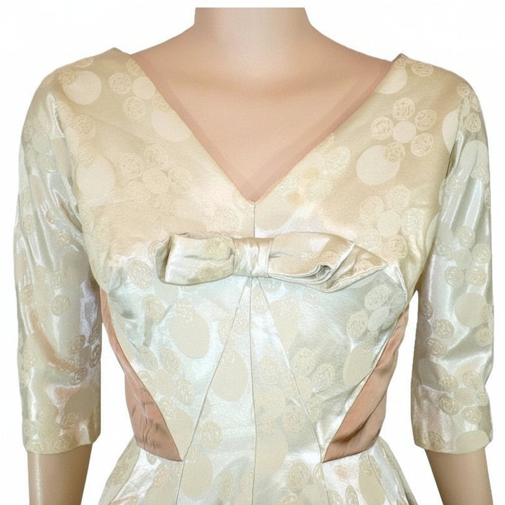 Side profile view of the 1960s vintage champagne white dress highlighting the Dolman sleeves and fitted waist.