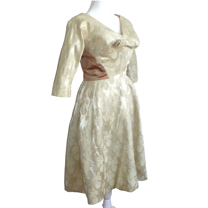 Side profile view of the 1960s vintage champagne white dress highlighting the Dolman sleeves and fitted waist.