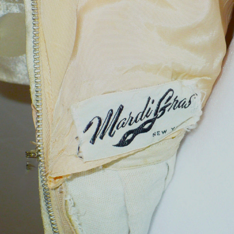 Close-up view of the Mardi Gras, New York vintage brand label stitched inside the dress.