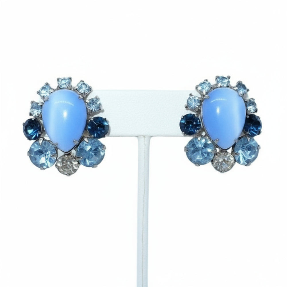 1960s Blue Rhinestone & Moonglow Lucite Mid-century Cocktail Earrings on a stand.