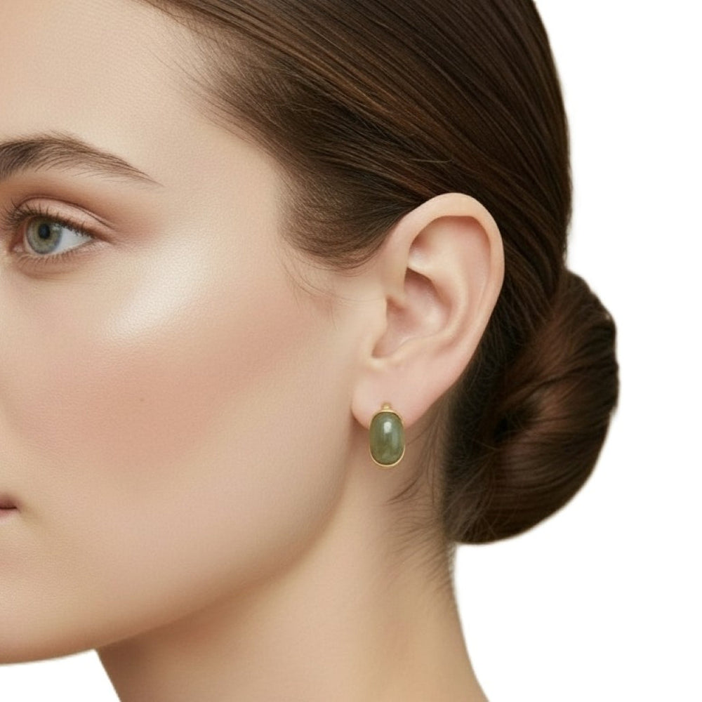 Close-up of a woman's ear wearing 1970s Vintage Givenchy Hoop Earrings.