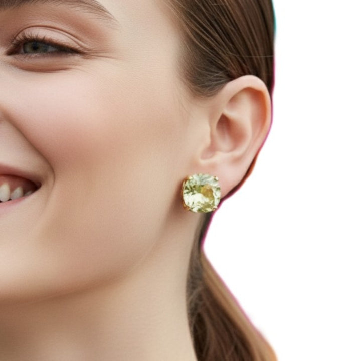 Close-up of a woman wearing a 1980s Chartreuse Green Bling Big Rhinestone Earrings on a white background.