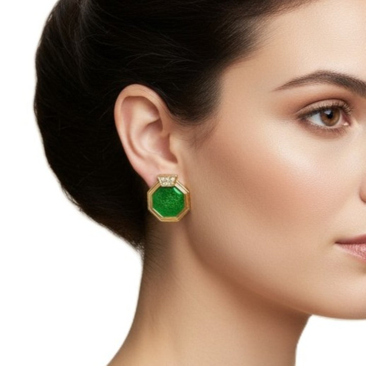 Close-up of a woman wearing 1980s Vintage Art Deco Revival Clip-on Earrings Green Enamel and gold with a white background