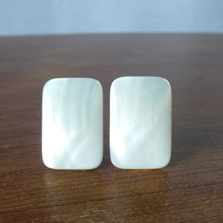1980s Mother of Pearl Gemstone Earrings - Clip On - resting on wood table.