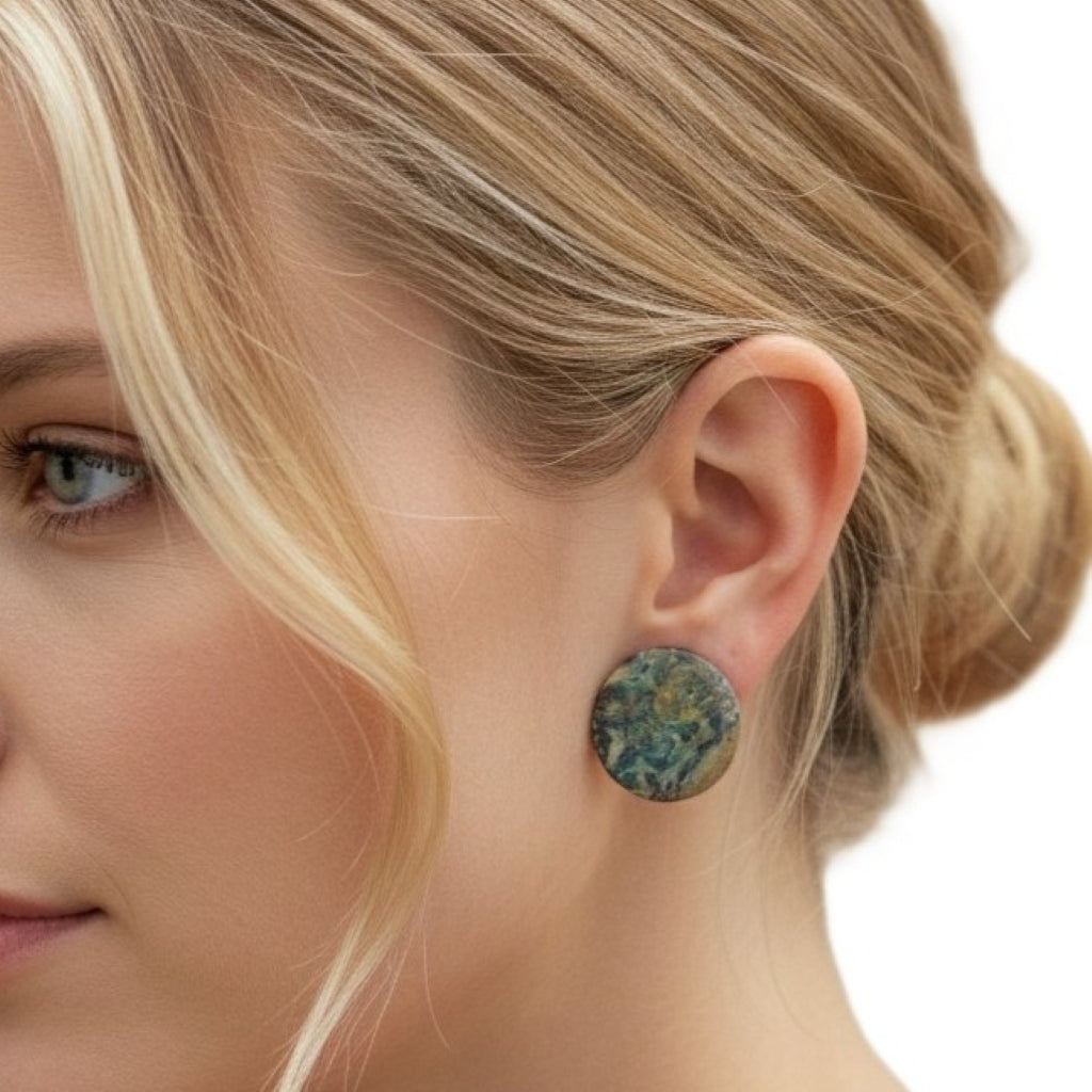 Close-up of a woman wearing a 1980s Vintage Large Round Ocean Jasper Gemstone Clip-on Statement Earrings with a blurred background