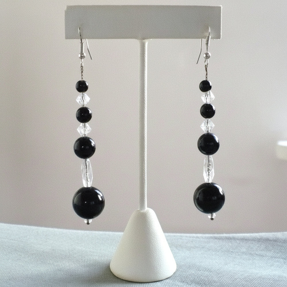 1920s Vintage Black Arabic Onyx Crystal Bead Dangling Pierced Earrings on display stand.