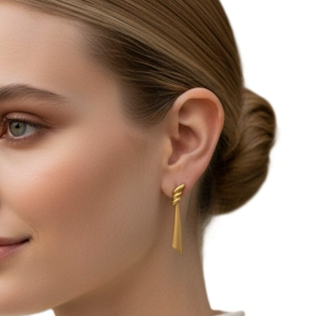 1980 Vintage Classical Draped Gold Tone Pierced Metal Earrings by Monet on woman.