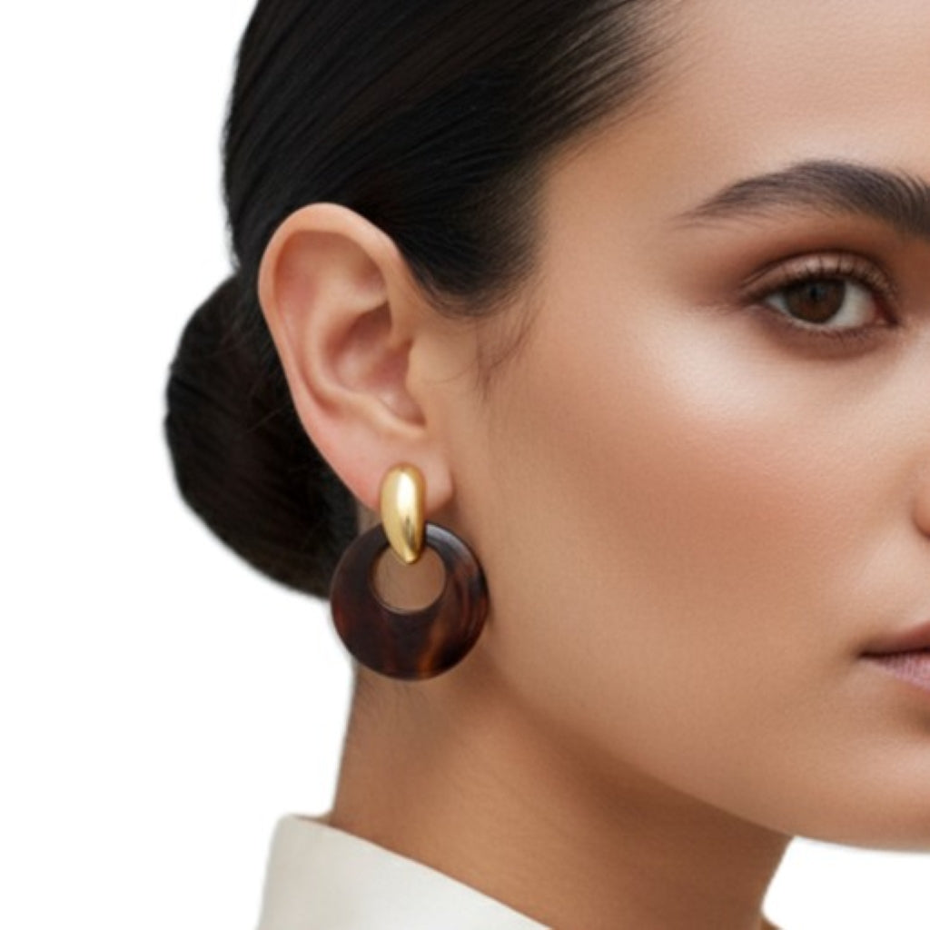 Close-up of a woman wearing 1980s Tortoise Door Knocker Pierced Interchangeable Earrings Vintage  with a neutral background