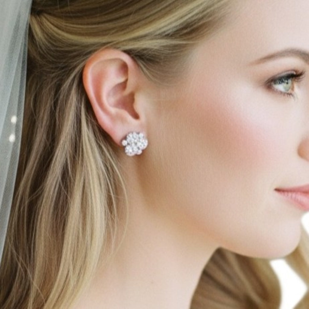 Close-up of a woman wearing a floral earring with a soft focus background bride wearing 1950s Vintage Rhinestone Cluster Cocktail earrings.