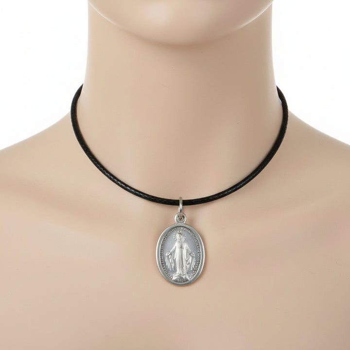 WWII 40s Vintage Miraculous Medal Pendant, Eloxal Aluminum Religious Medal t on a mannequin neck against a white background.