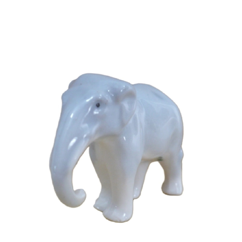 1930s Vintage Miniature German Porcelain Elephant Figurine by Pfeffer Porzellan against a white background.