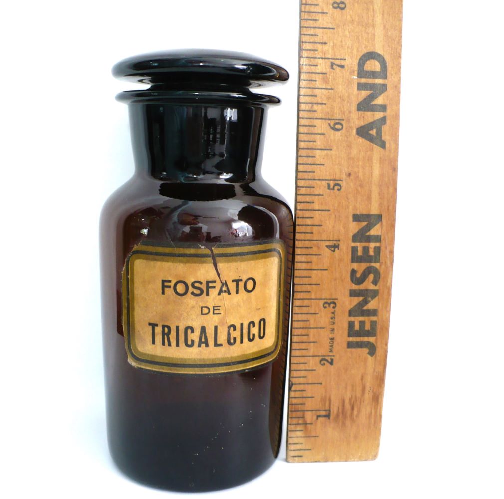 Apothecary jar next to ruler