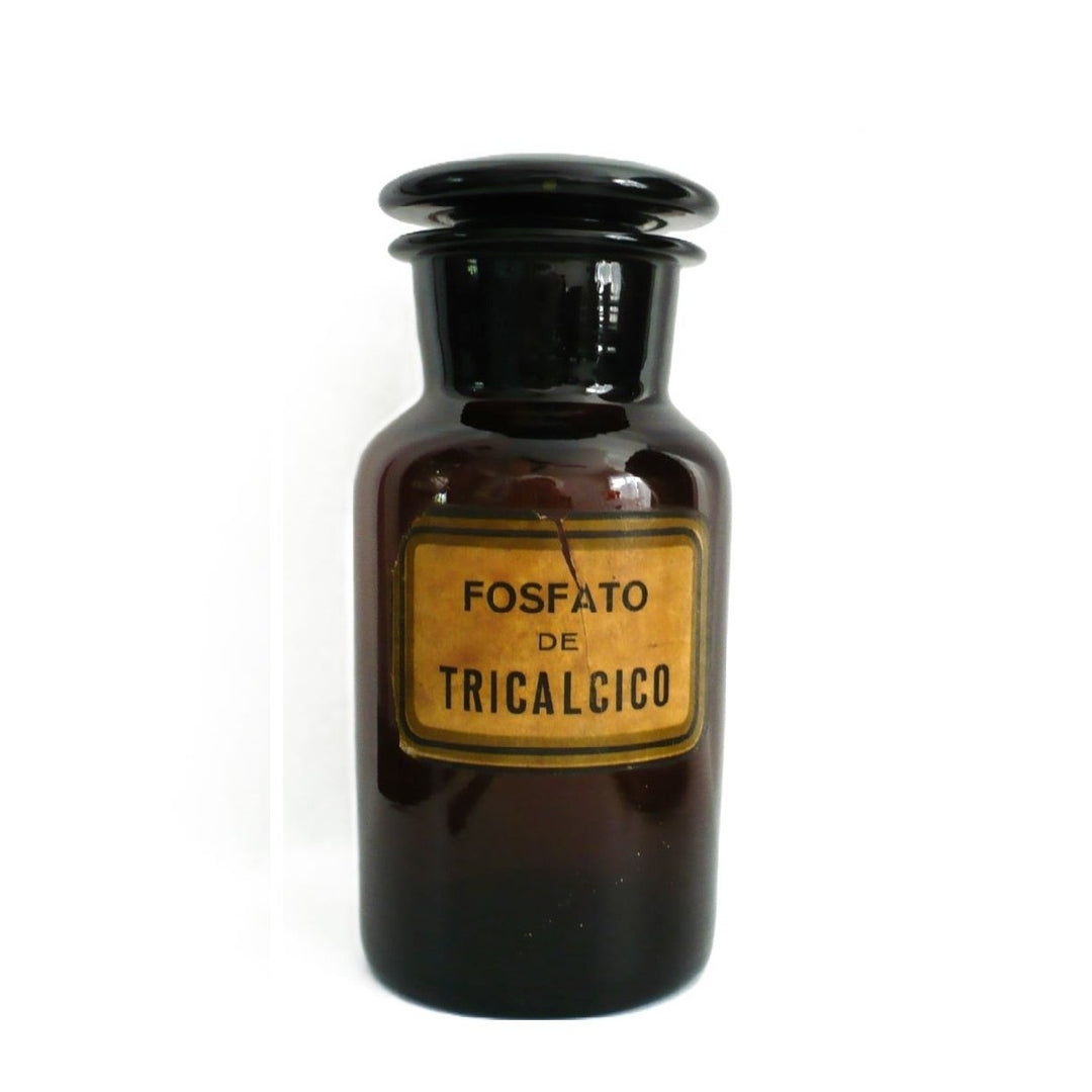 1930s hand-blown amber glass apothecary jar from Argentina featuring original FOSFATO DE TRICALCICO paper label and ground glass stopper, shown upright on a white background.
