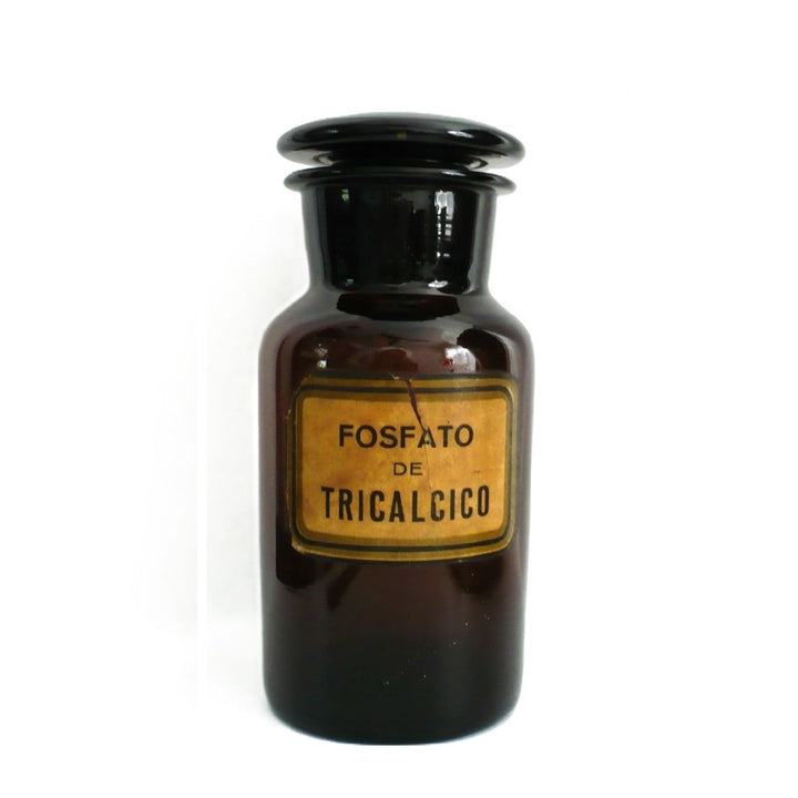 1930s hand-blown amber glass apothecary jar from Argentina featuring original FOSFATO DE TRICALCICO paper label and ground glass stopper, shown upright on a white background.