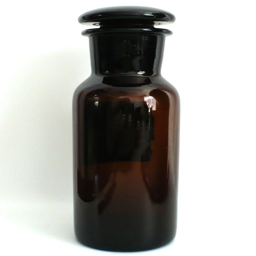 Rear view of the vintage 1930s amber glass apothecary jar, highlighting the seamless, heavy turn-molded glass body.