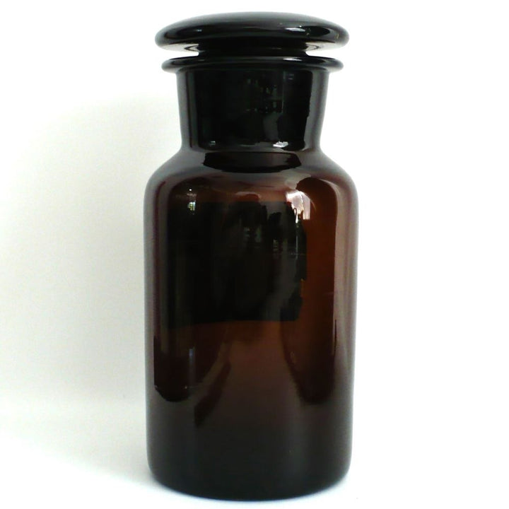 Rear view of the vintage 1930s amber glass apothecary jar, highlighting the seamless, heavy turn-molded glass body.