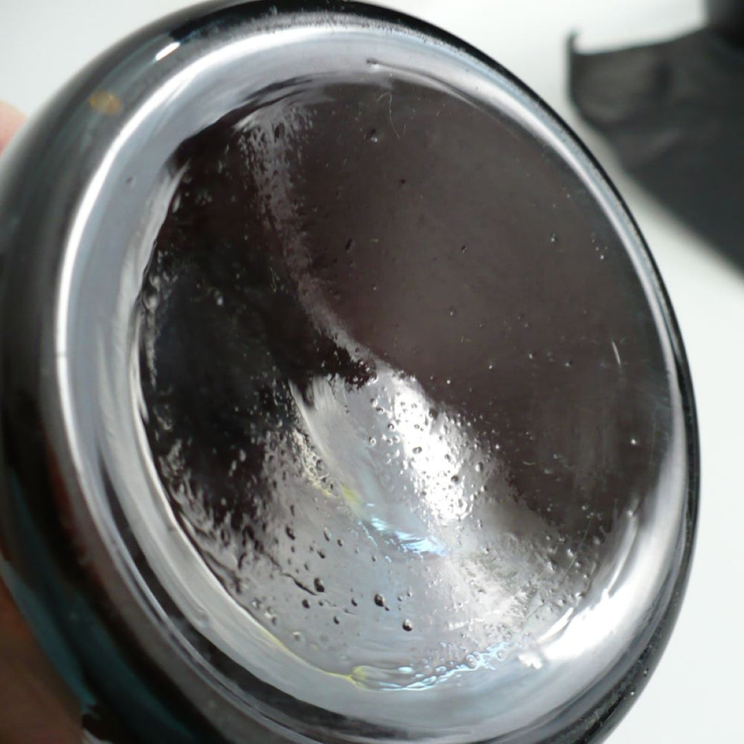 Close-up of the base of 1930 Amber Fosfato de Tricalcico Apothecary Jar.