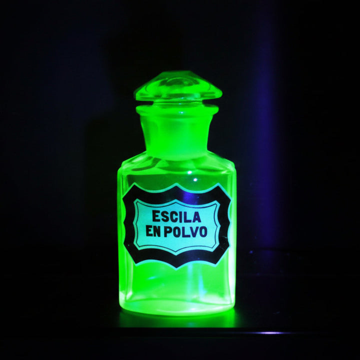 Uranium glass apothecary bottle under black ight.