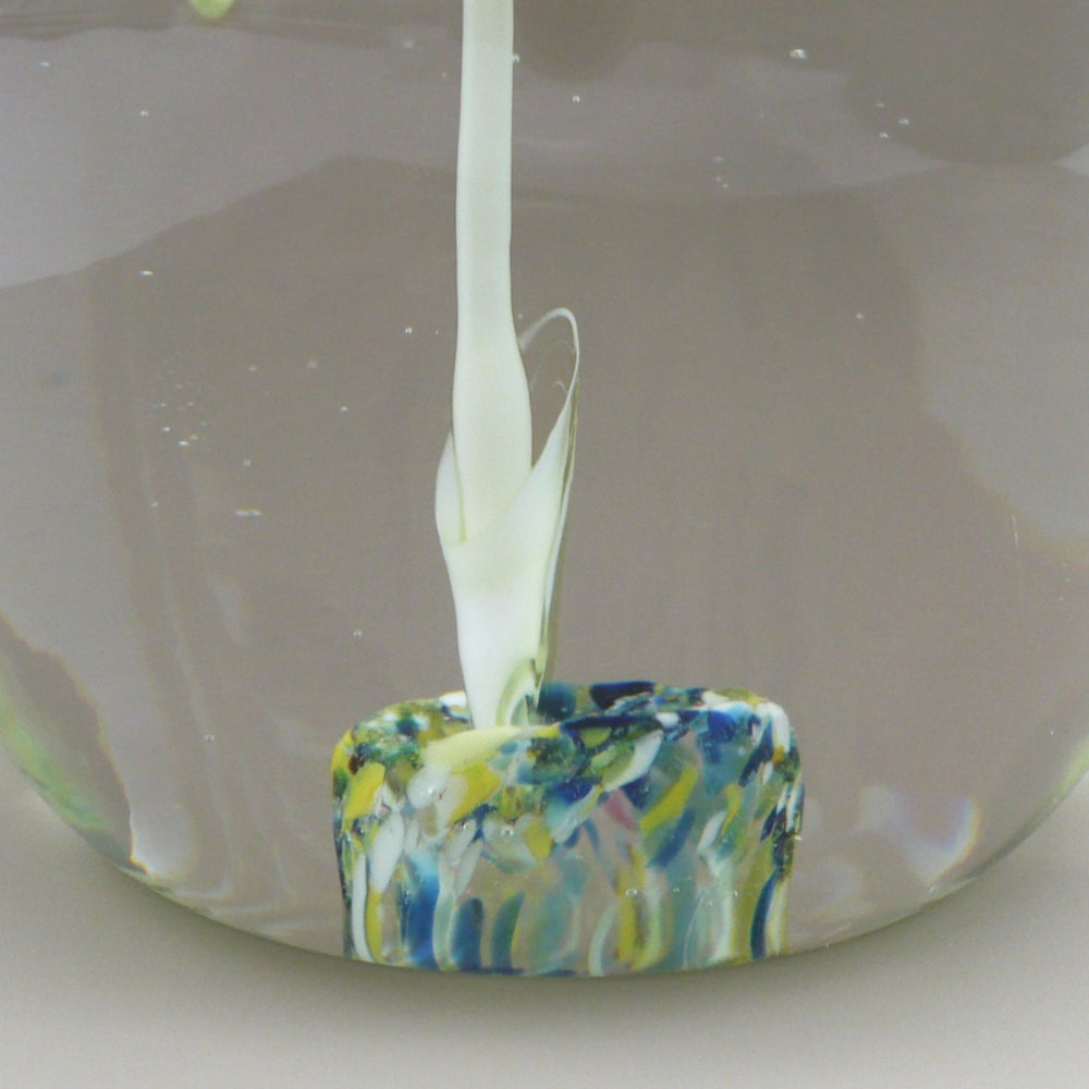 A close-up of a 1960s Cristaleria Querandi Paperweight near bottom, side view details.