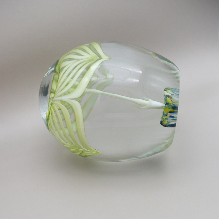 A clear glass paperweight on its side 1960s Cristaleria Querandi Paperweight.