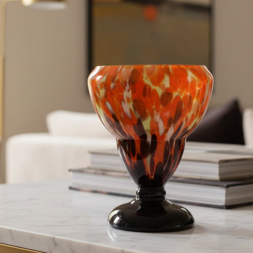 Colorful 1930 Bohemian Spatter Glass Cabinet Vase, attr. to Steinwald, on a marble surface with books in the background