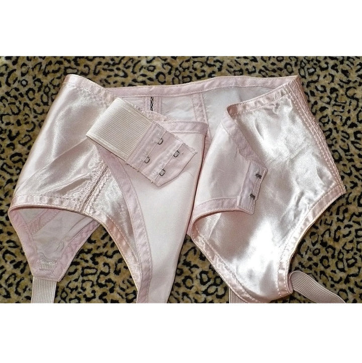 1940s Vintage Pin-up Girl Pink Satin and Lace Garter Belt on a leopard print background