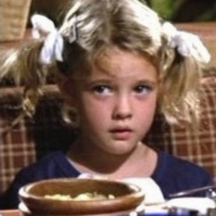 Gertie in "E.T." wearing white yarn hair ties, ponytail ribbons (1982).