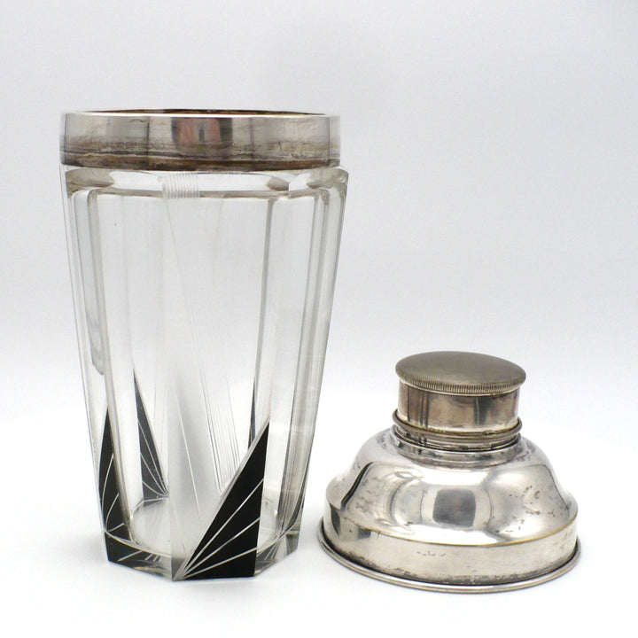 A vintage 1930s Karl Palda Art Deco Crystal Cocktail Shaker Czechoslovakia with a faceted clear crystal body, black enamel accents, and a polished silver metal lid shown removed and by its side.