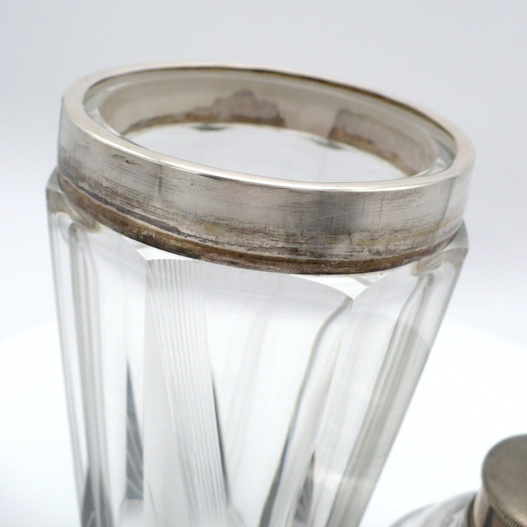 A close-up of the silver plated rim on vintage 1930s Karl Palda Art Deco Crystal Cocktail Shaker.