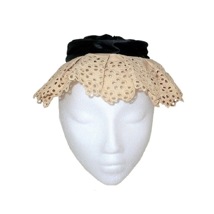 Edwardian lady's maid mobcap hat featuring a black silk crown and tea-dyed lace brim displayed on a white mannequin head.