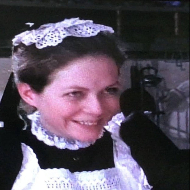 Historical reference photo of a domestic housemaid wearing a traditional mob cap.