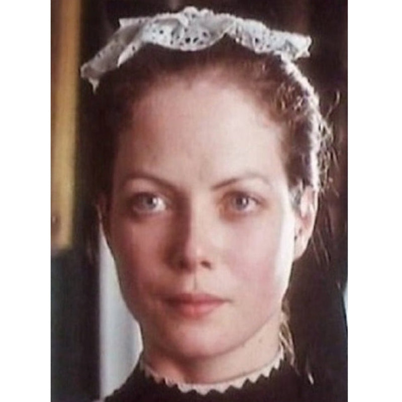Vintage film still showing a period costume featuring a traditional housemaid mob cap.