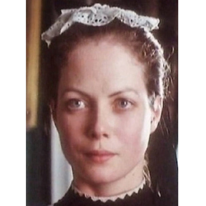 Vintage film still showing a period costume featuring a traditional housemaid mob cap.