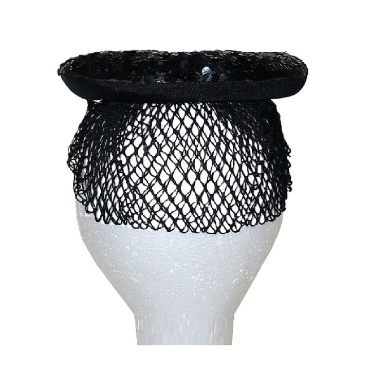 Back view of the 1930s black gelatin sequined cocktail beret and mesh veil on a white mannequin head.