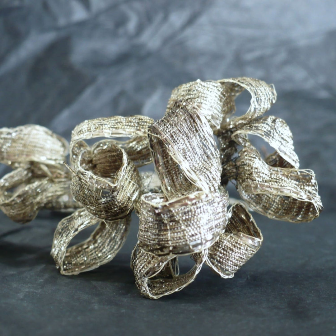Detailed view of the 1920s French silver-wrapped silk hair headpiece.