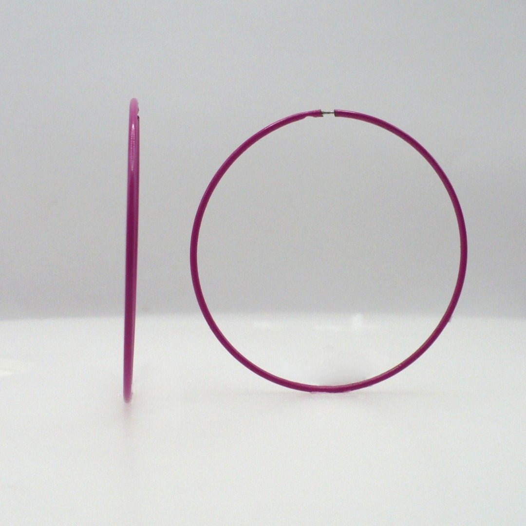1980s pink pop art Memphis style 2-inch hoop earrings shown side-on and front-facing against a neutral white background.

