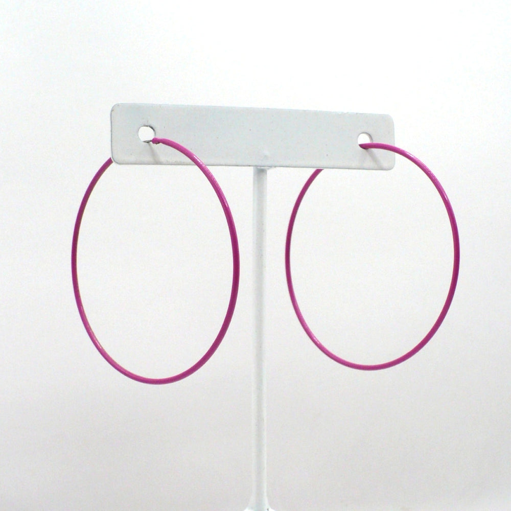 1980s pink pop art Memphis style 2-inch hoop earrings shown side-on and front-facing against a neutral white background.