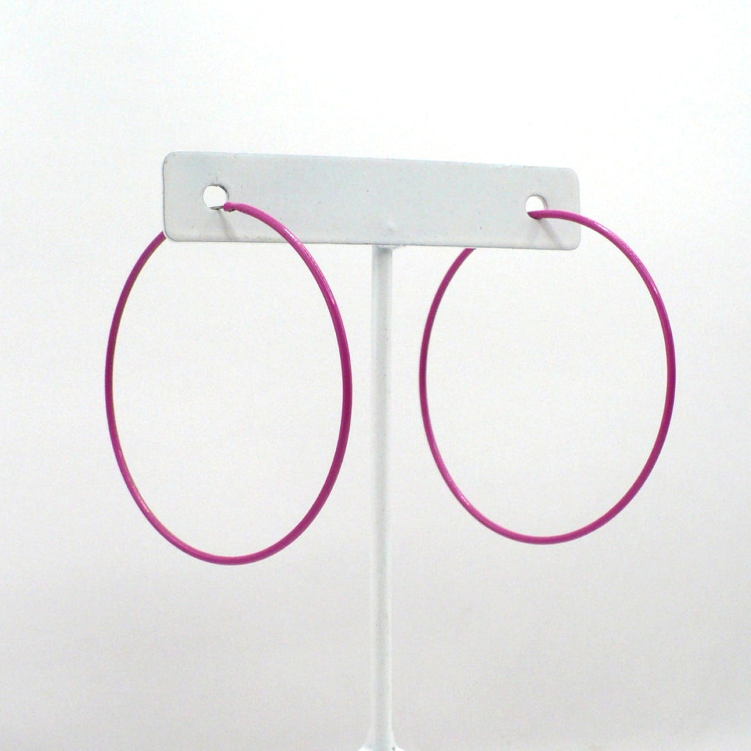 1980s pink pop art Memphis style 2-inch hoop earrings shown side-on and front-facing against a neutral white background.