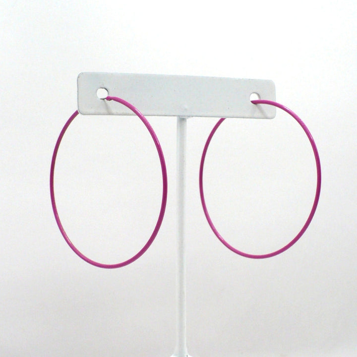 1980s pink pop art Memphis style 2-inch hoop earrings shown side-on and front-facing against a neutral white background.