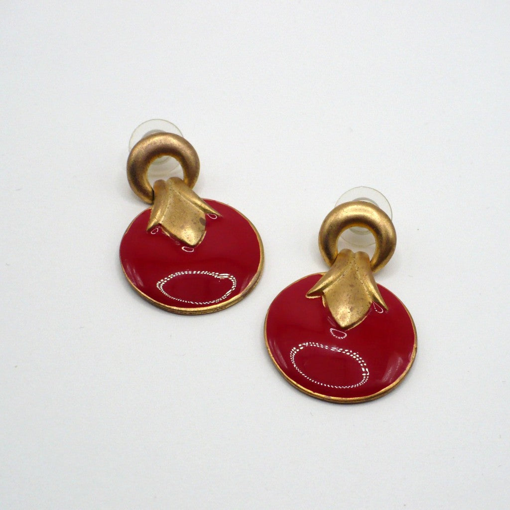 1980s vintage neo-baroque scarlet red and gold-tone door knocker statement earrings laid flat against a neutral background.