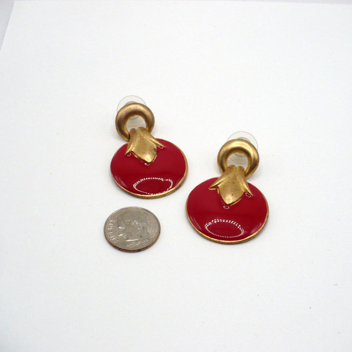 1980s vintage neo-baroque scarlet red and gold-tone door knocker statement earrings laid flat against a neutral background next o a dime for scale.