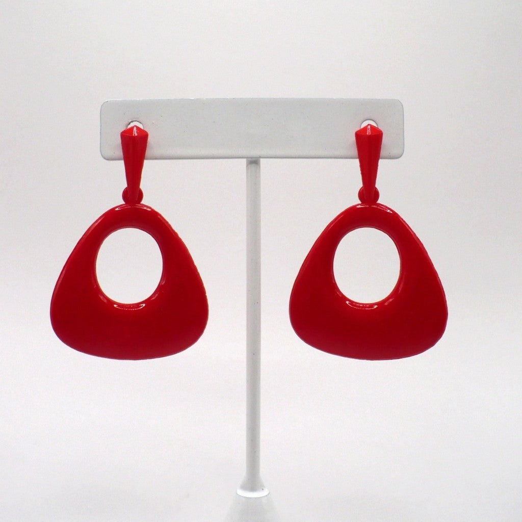 1980s vintage mod revival lipstick red molded nylon drop earrings with a geometric rounded triangle shape and central open circle, displayed on a white stand.