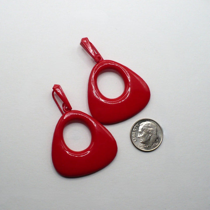 Vintage 80s lipstick red geometric statement earrings, hypoallergenic non-metal plastic drop jewelry, mod revival space age fashion accessory., on flat surface next to a dime for scale.
