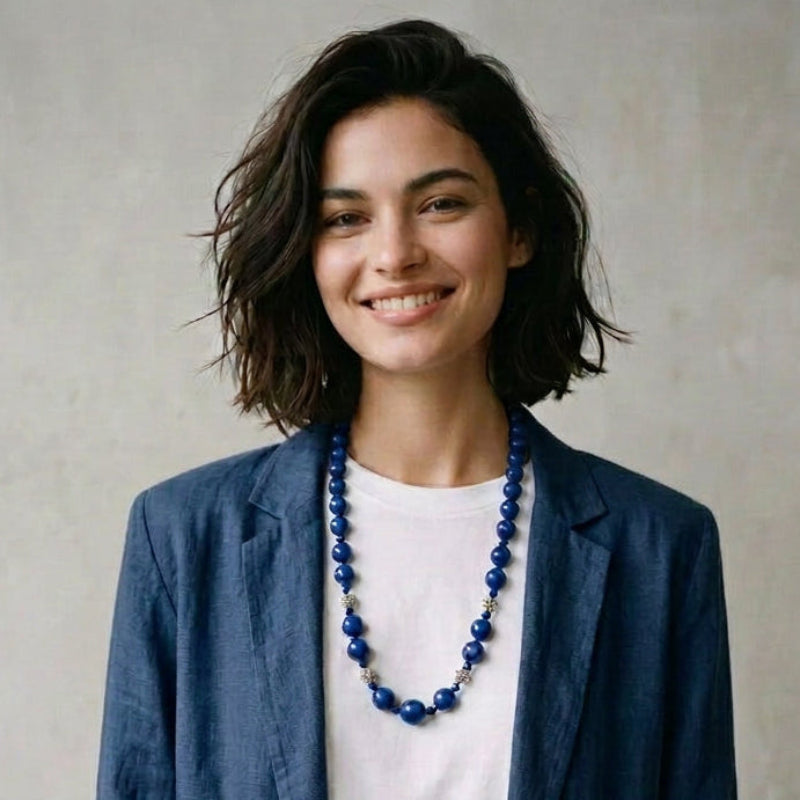 Model wearing the 1970s vintage 27-inch lapis lazuli and sterling silver beaded necklace over a blazer.