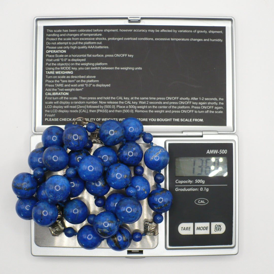 1970s vintage lapis lazuli and sterling silver beaded necklace weighed on a digital scale.